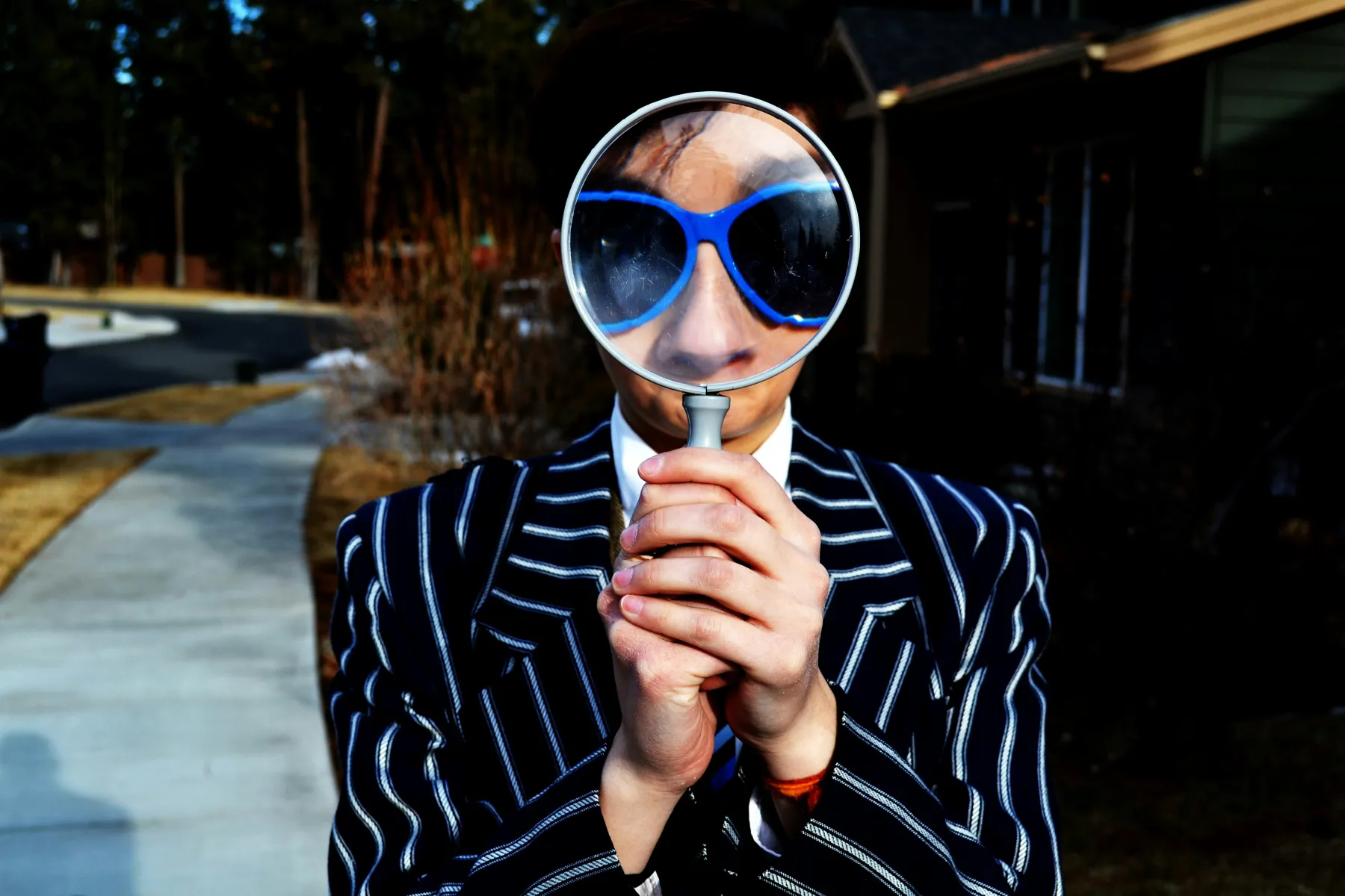 Woman with a magnifying glass. Photo by Marten Newhall on Unsplash. 